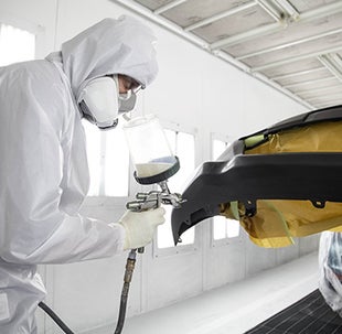 Collision Center Technician Painting a Vehicle | Billion Toyota of Sioux Falls in Sioux Falls SD